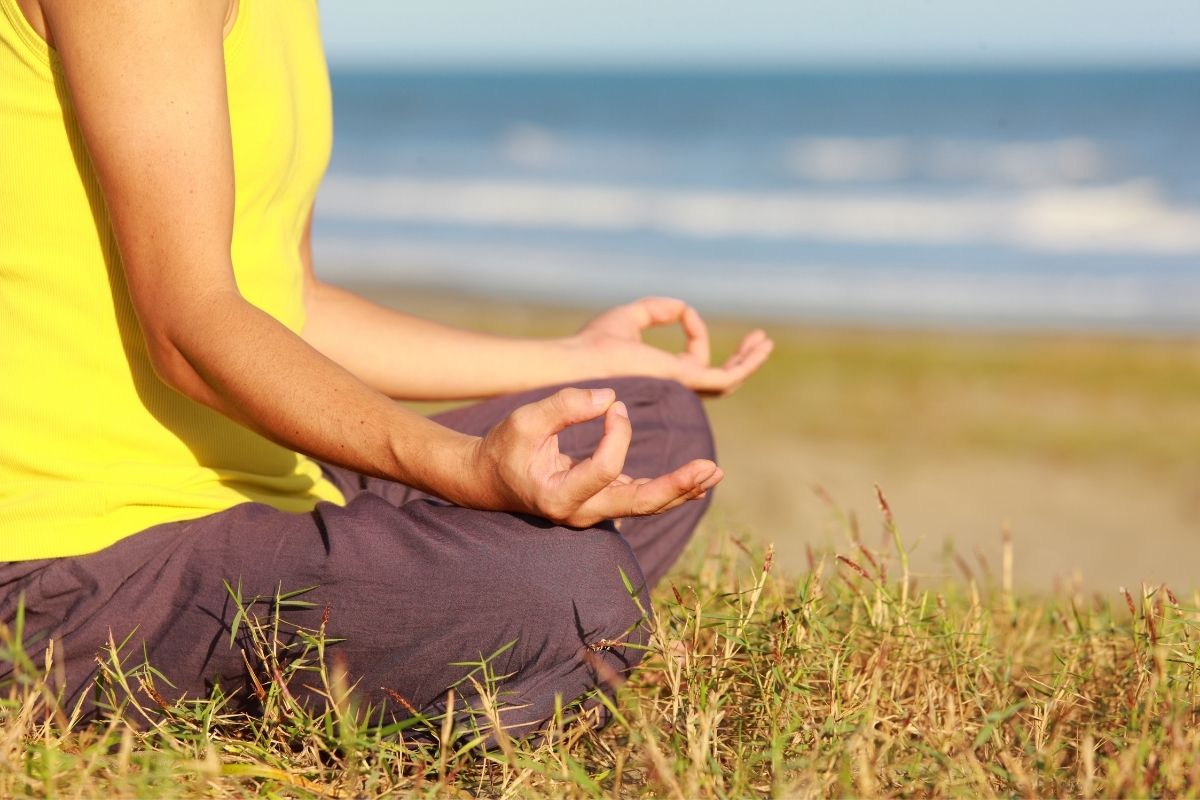 A man meditating calmly alone.