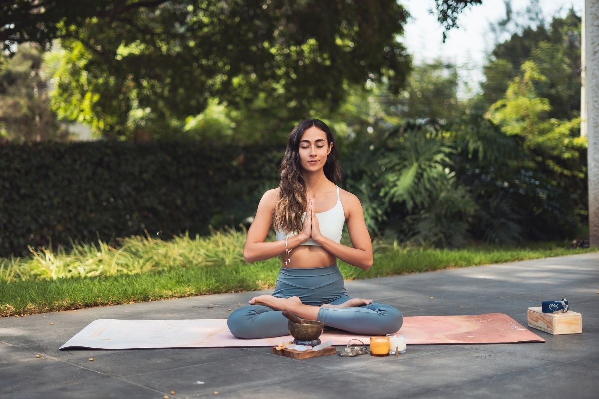 Young woman meditating outdoors.