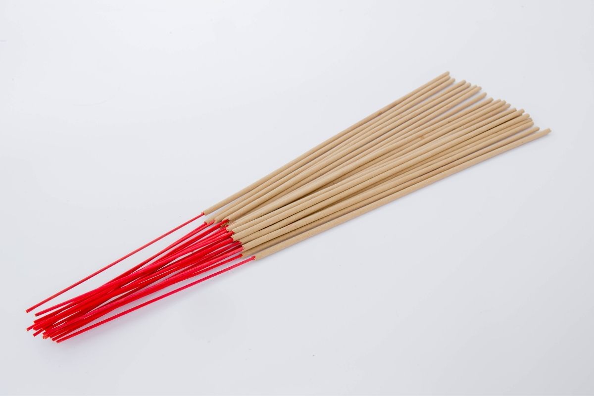 A group of joss sticks placed on a white surface.